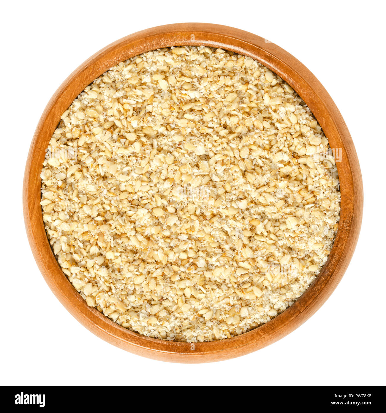 Gomashio in wooden bowl, also called gomasio. Dry condiment, made of toasted sesame seeds and salt, used in Japanese cuisine to sprinkle it over rice. Stock Photo