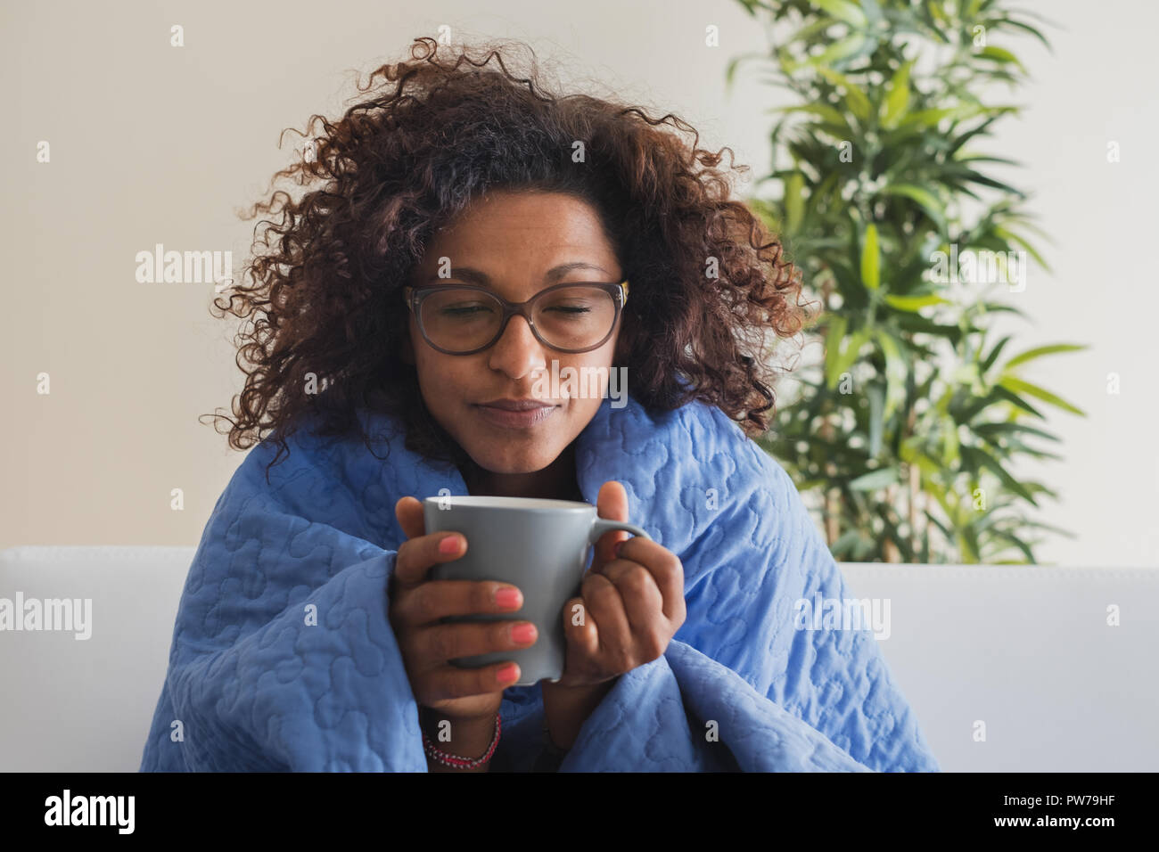 Black woman drinking hot tea and feeling comfortable Stock Photo Alamy