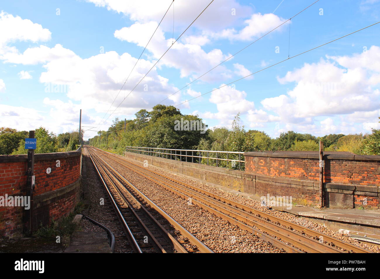 Railway tracks at a train station on a summer's day Stock Photo Alamy