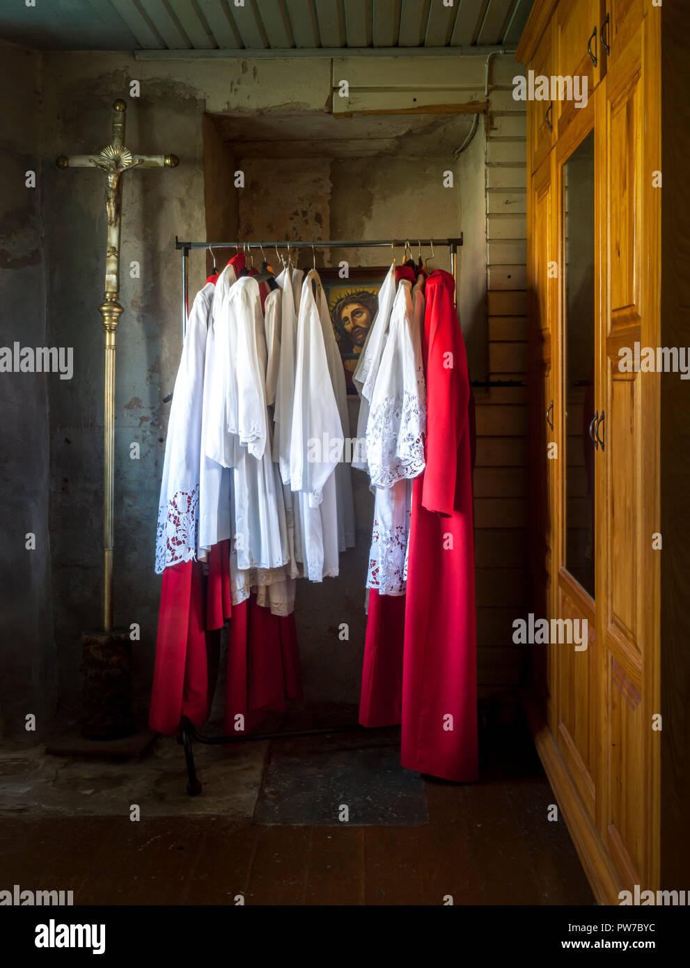 Kuldiga, Latvia. 3rd September. 2014.  Altar boy vestments hanging  in the sacristy of the Holy Trinity Church in Kuldiga, Latvia. Stock Photo