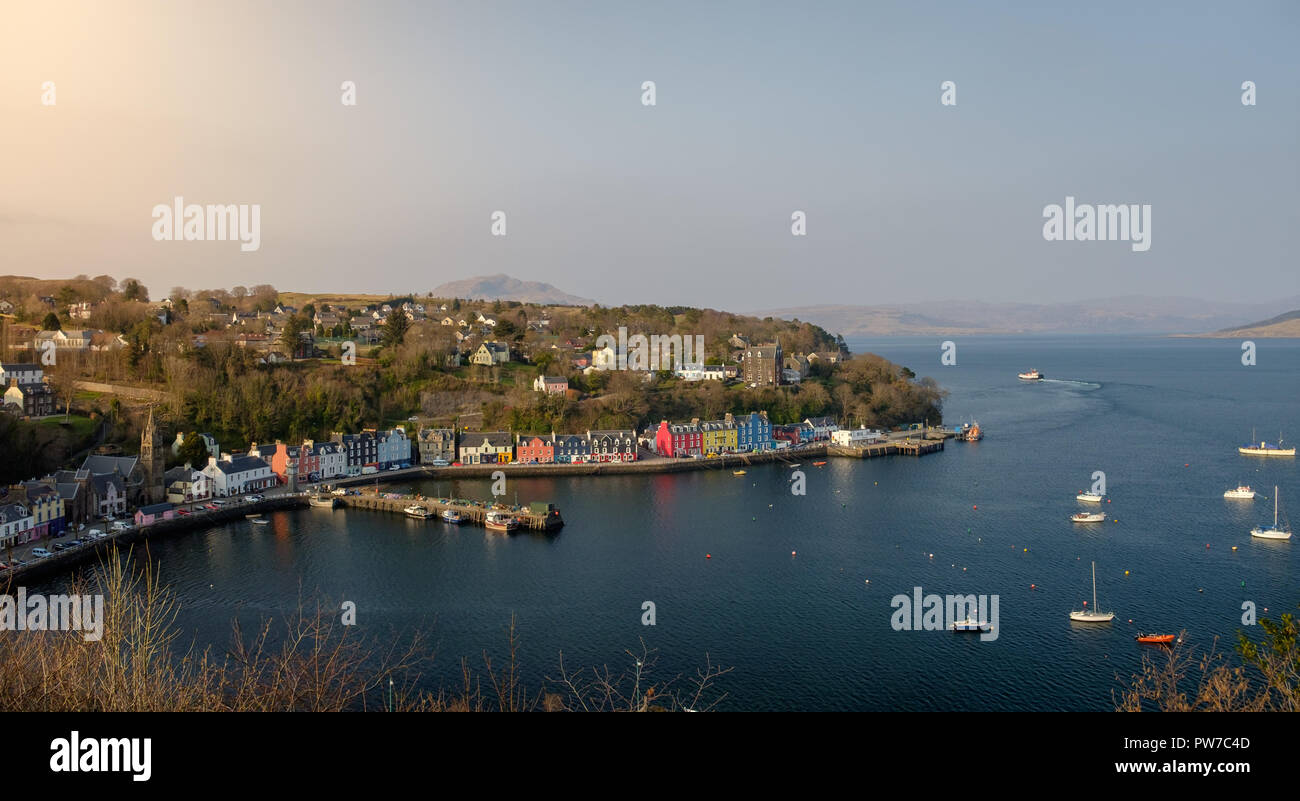 Aeial view in morning light of Tobermory Bay on the Isle of Mull. Scotland mainland highland peaks in the background Stock Photo