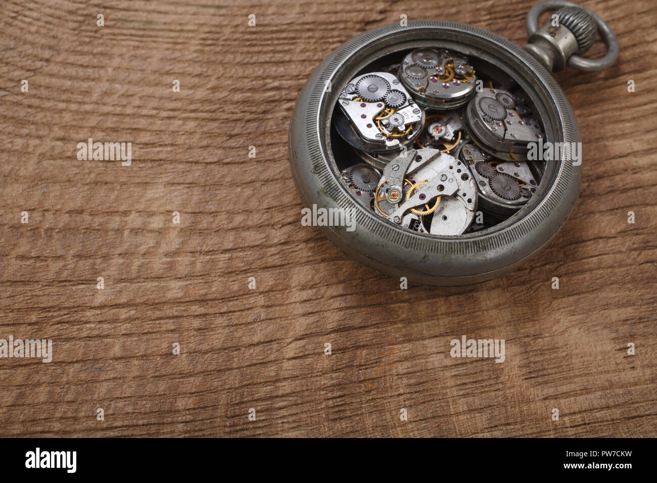 broken vintage pocket watch on wooden background Stock Photo Alamy