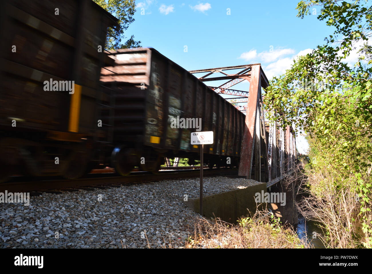A freight train passes over the Tar River on a steel trestle bridge in Rocky Mount, North Carolina. Stock Photo