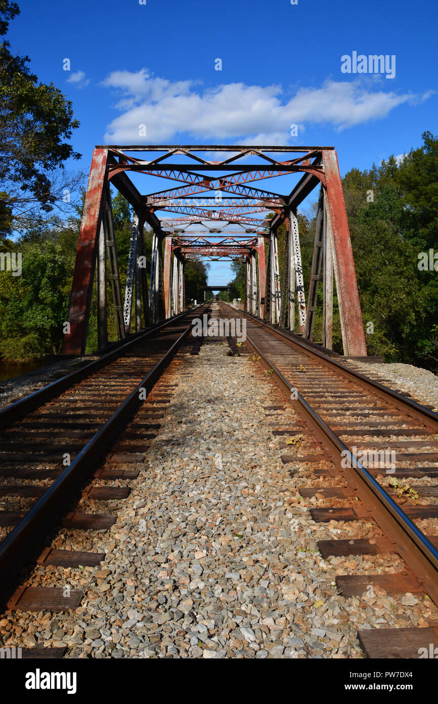 Looking down the tracks at a steel trestle bridge over the Tar River in Rocky Mount, North Carolina. Stock Photo