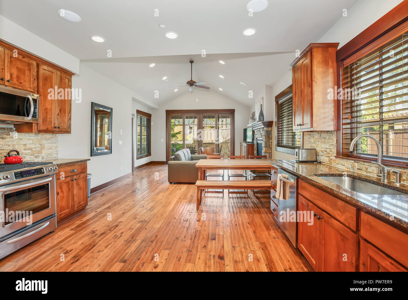 Open Floor Plan Kitchen Room With Stone Backsplash Granite