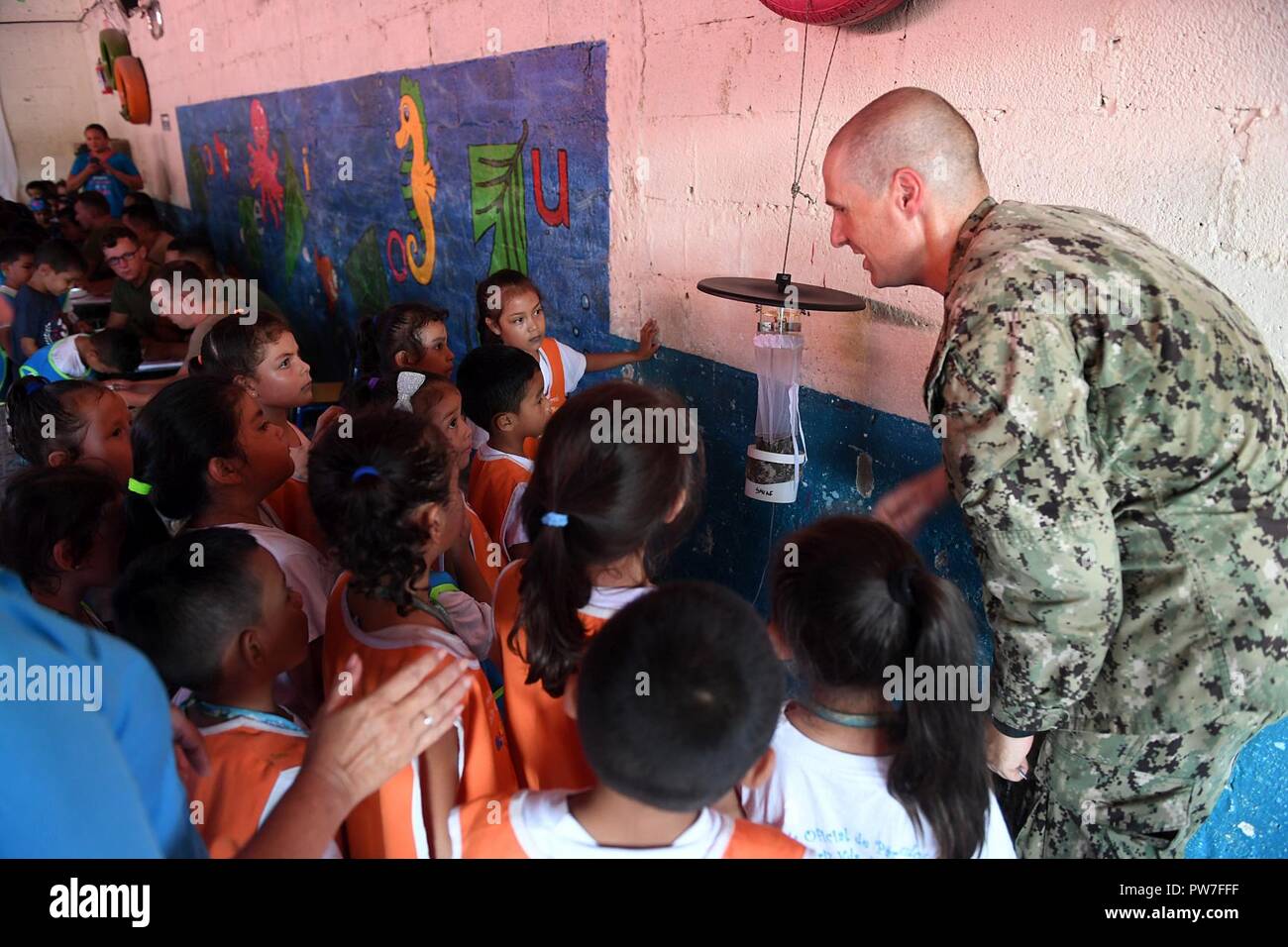 PUERTO BARRIOS, Guatemala (Sept. 22, 2017) Lt. Cmdr. Ian Sutherland, technical director for the Navy Entomology Center of Excellence, shows students a mosquito trap at Escuela Natalia Corriz Viuda de Morales, a Guatemalan primary school, during a Southern Partnership Station 17 community relations project (COMREL). SPS 17 is a U.S. Navy deployment executed by U.S. Naval Forces Southern Command/U.S. 4th Fleet, focused on subject matter expert exchanges with partner nation militaries and security forces in Central and South America. Stock Photo