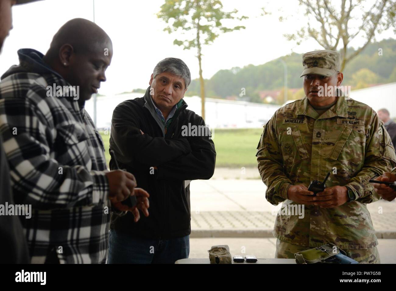 A Raytheon contractor (left) instructs Peter Rocha (right), Chief of