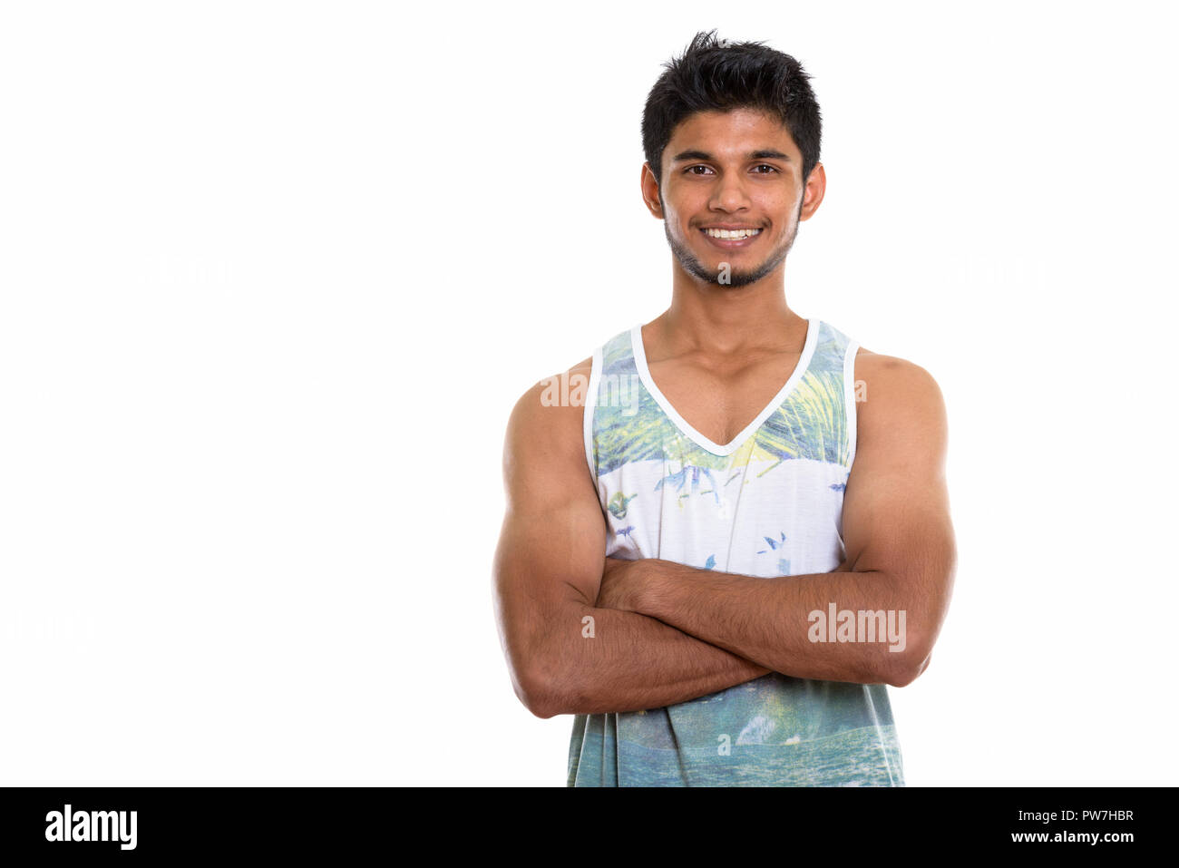 Studio shot of young happy Indian man smiling with arms crossed Stock ...