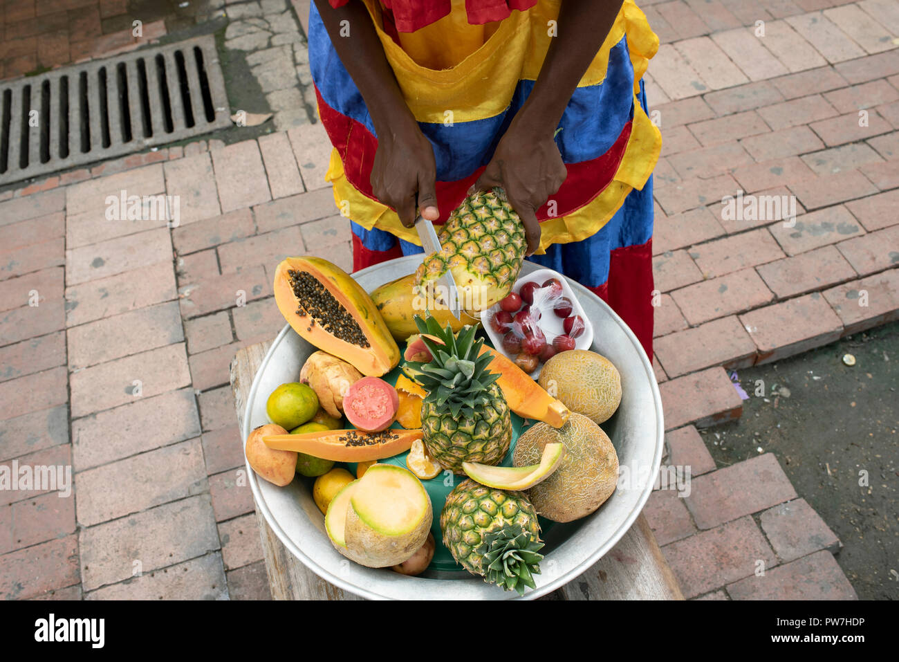 Unidentifiable street fruit vendor in action. Cartagena de Indias, Colombia. Sep 2018 Stock Photo