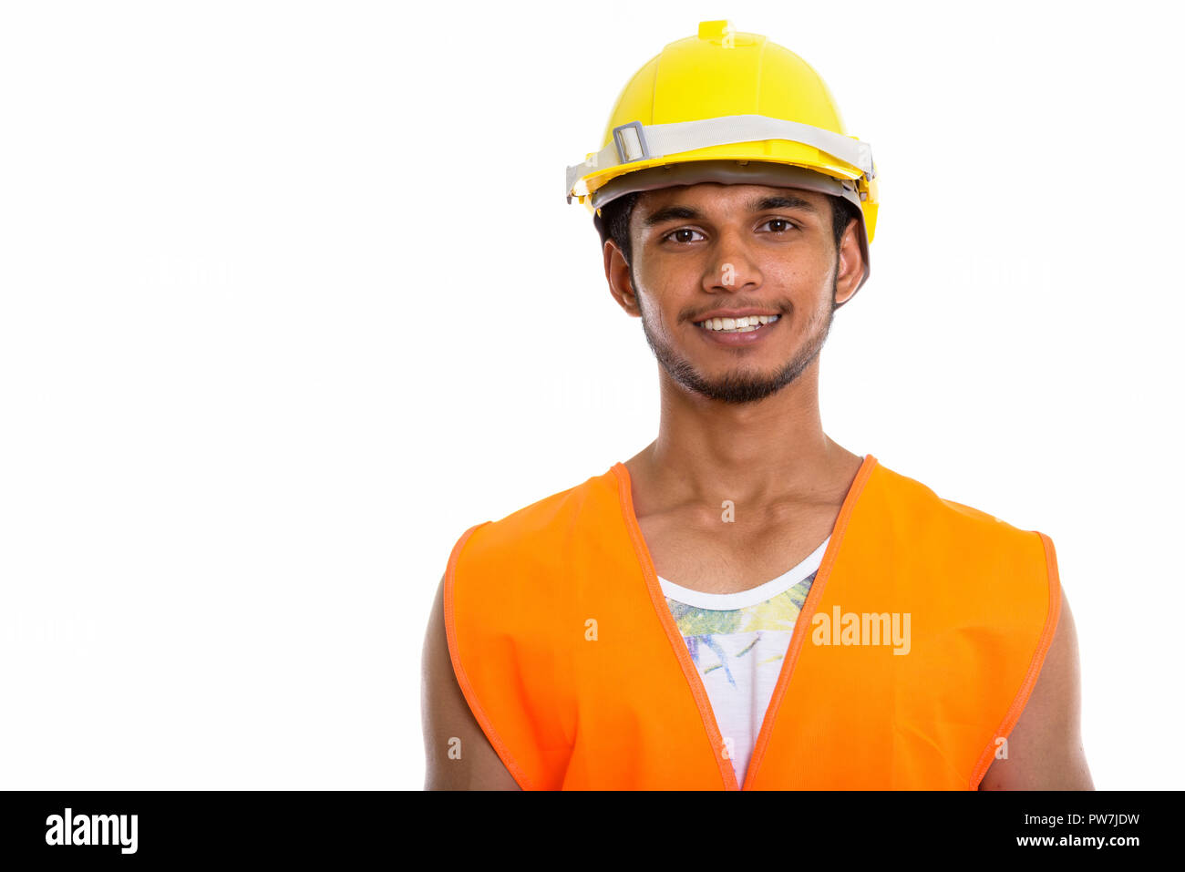 Studio shot of young happy Indian man construction worker smilin Stock Photo