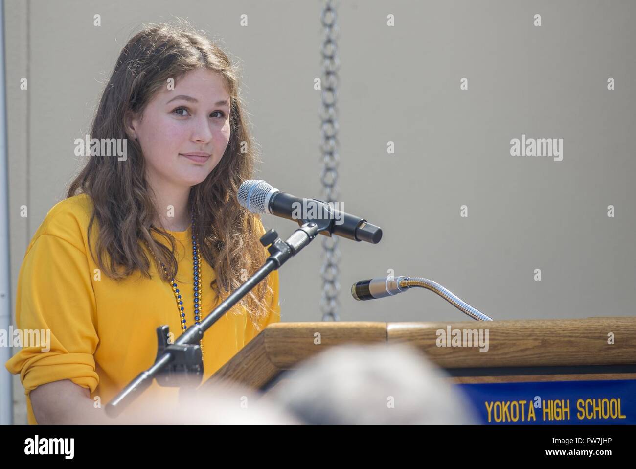 Sarah Heino, Yokota High School student body president, speaks to the audience during the Yokota High School ribbon cutting ceremony, Sept. 25, 2017, at Yokota Air Base, Japan. The Yokota High School’s mascot is the panther and the school’s motto is, “Life is about chances and opportunities. Never leave anything to chance and never let an opportunity get away.” – Lily Tomlin. Stock Photo