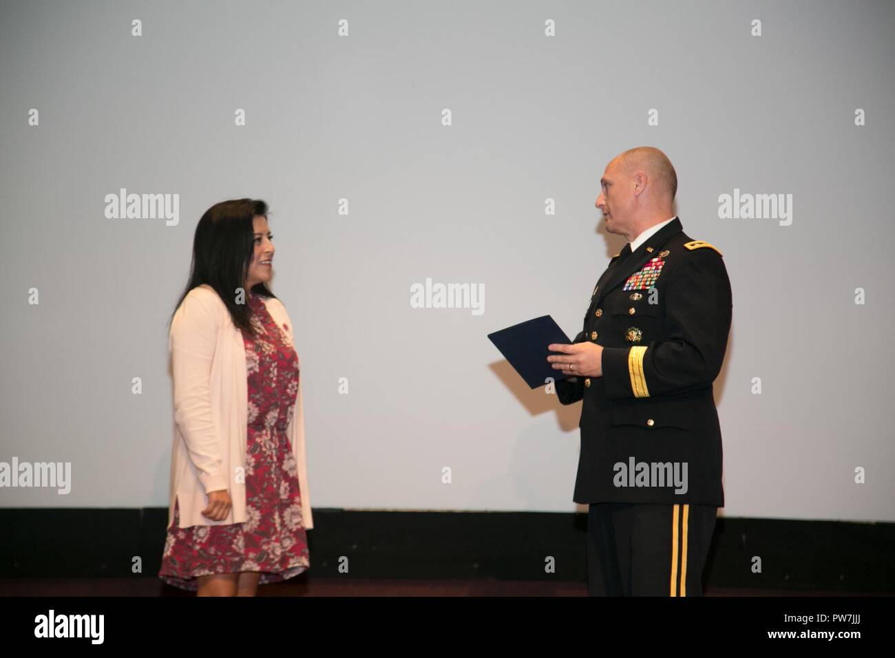 U.S. Army Lt. Gen. Edward Daly, Army Materiel Command deputy commander and Redstone senior commander, presents an award to Christine Chavez, the keynote speaker during the Hispanic-American Heritage Month Observance Sept. 25, 2017 at Redstone Arsenal, Alabama.  Chavez is the granddaughter of labor leader and civil rights activist Cesar Chavez. Stock Photo