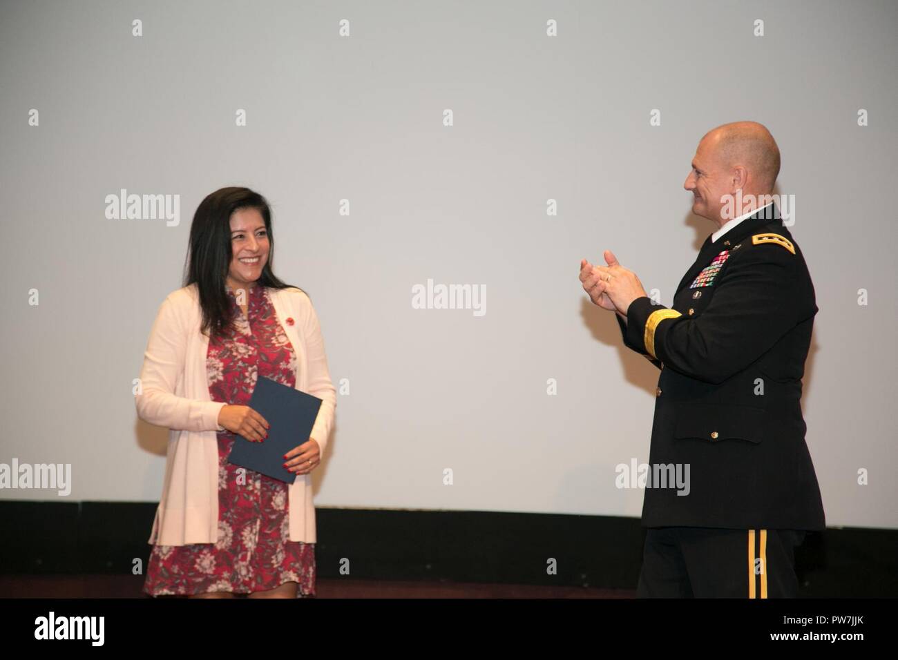 U.S. Army Lt. Gen. Edward Daly, Army Materiel Command deputy commander and Redstone senior commander, presents an award to Christine Chavez, the keynote speaker during the Hispanic-American Heritage Month Observance Sept. 25, 2017 at Redstone Arsenal, Alabama.  Chavez is the granddaughter of labor leader and civil rights activist Cesar Chavez. Stock Photo