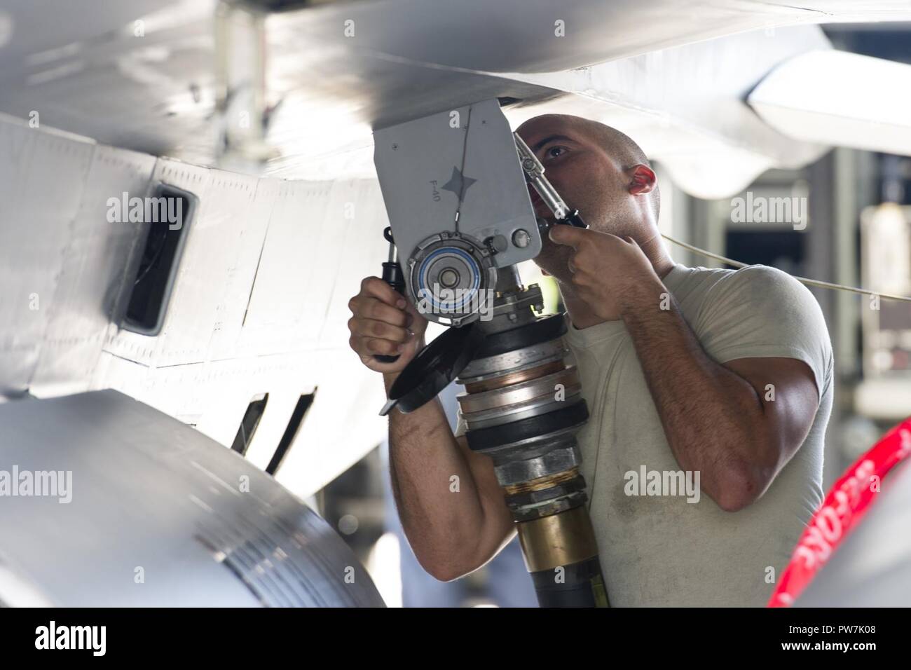 U.S. Air Force Senior Airman Juan Suero, crew chief, 482nd Aircraft Maintenance Squadron, Homestead Air Reserve Base, Florida, refuels an F-16C Viper from the 482nd Fighter Wing, after the aircraft returned home from being evacuated September 21, 2017. The aircraft of the fighter wing were evacuated to Texas in advance of Hurricane Irma’s landfall with Florida. Stock Photo