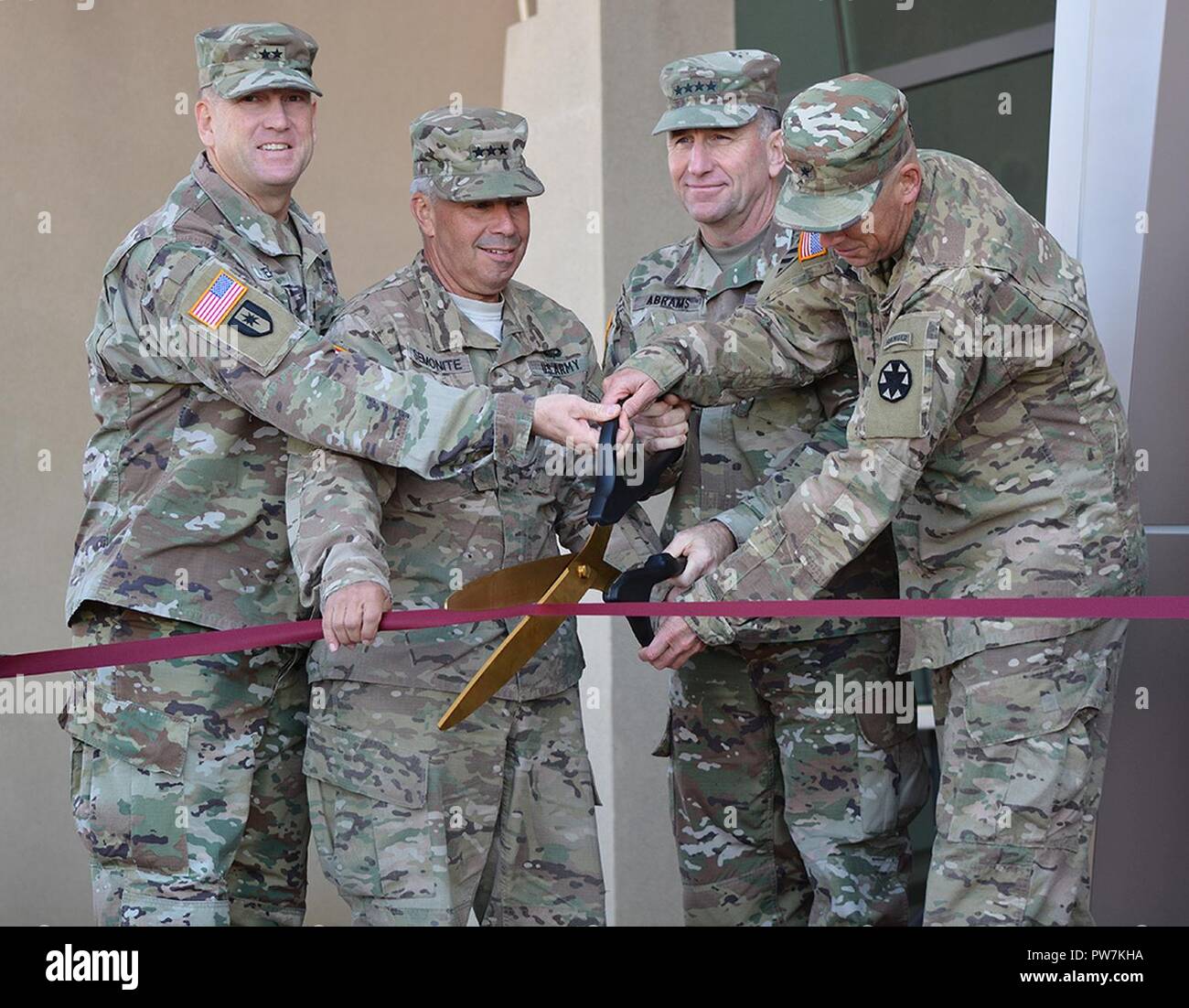 From left to right, Maj. Gen. Thomas Tempel, commanding general, Regional Health Command-Central; Lt. Gen. Todd Semonite, commanding general, U.S. Army Corps of Engineers; Gen. Robert Abrams, commanding general, U.S. Army Forces Command; and Brig. Gen. Jeff Broadwater, commanding general, National Training Center and Fort Irwin, cut the ribbon during a Sept. 21 ceremony signifying the opening of the new Weed Army Community Hospital at Fort Irwin, California. Stock Photo