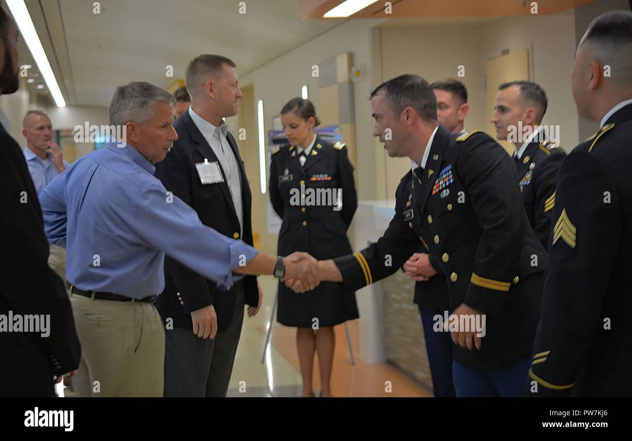 Lt. Gen. Todd Semonite, commanding general, U.S. Army Corps of Engineers, left, and Maj. Gen. Thomas Tempel Jr., commanding general, Regional Health Command-Central, second from left, greet Soldiers during a Sept. 20 tour of the new Weed Army Community Hospital at Fort Irwin, California. Stock Photo