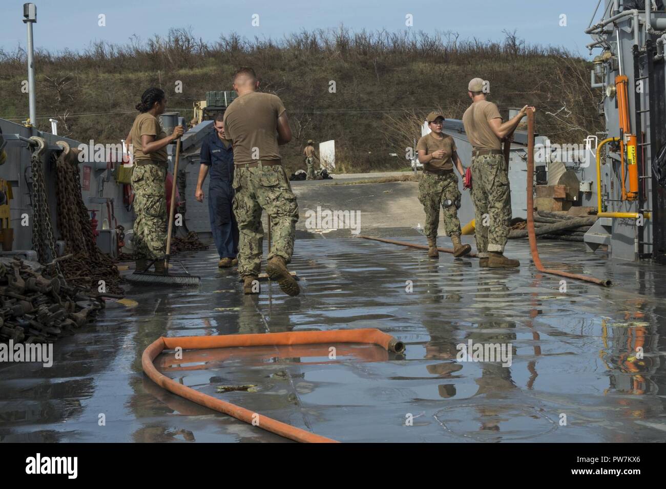 PUERTO RICO, (Sept. 24, 2017) – Sailors, assigned to Assault Craft Unit Two, make the deck of a landing craft utility ready to take on troops and cargo in Puerto Rico, Sept. 24, 2017. The Department of Defense is supporting Federal Emergency Management Agency (FEMA), the lead federal agency, in helping those affected by Hurricane Maria to minimize suffering and is one component of the overall whole-of-government response effort. Stock Photo