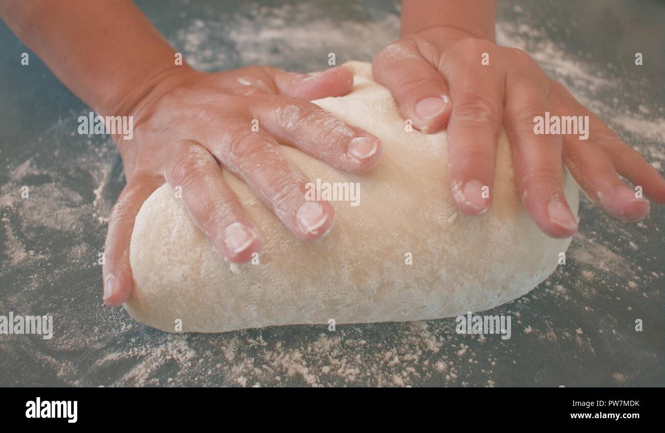 Hands of a woman kneading dough Stock Photo - Alamy