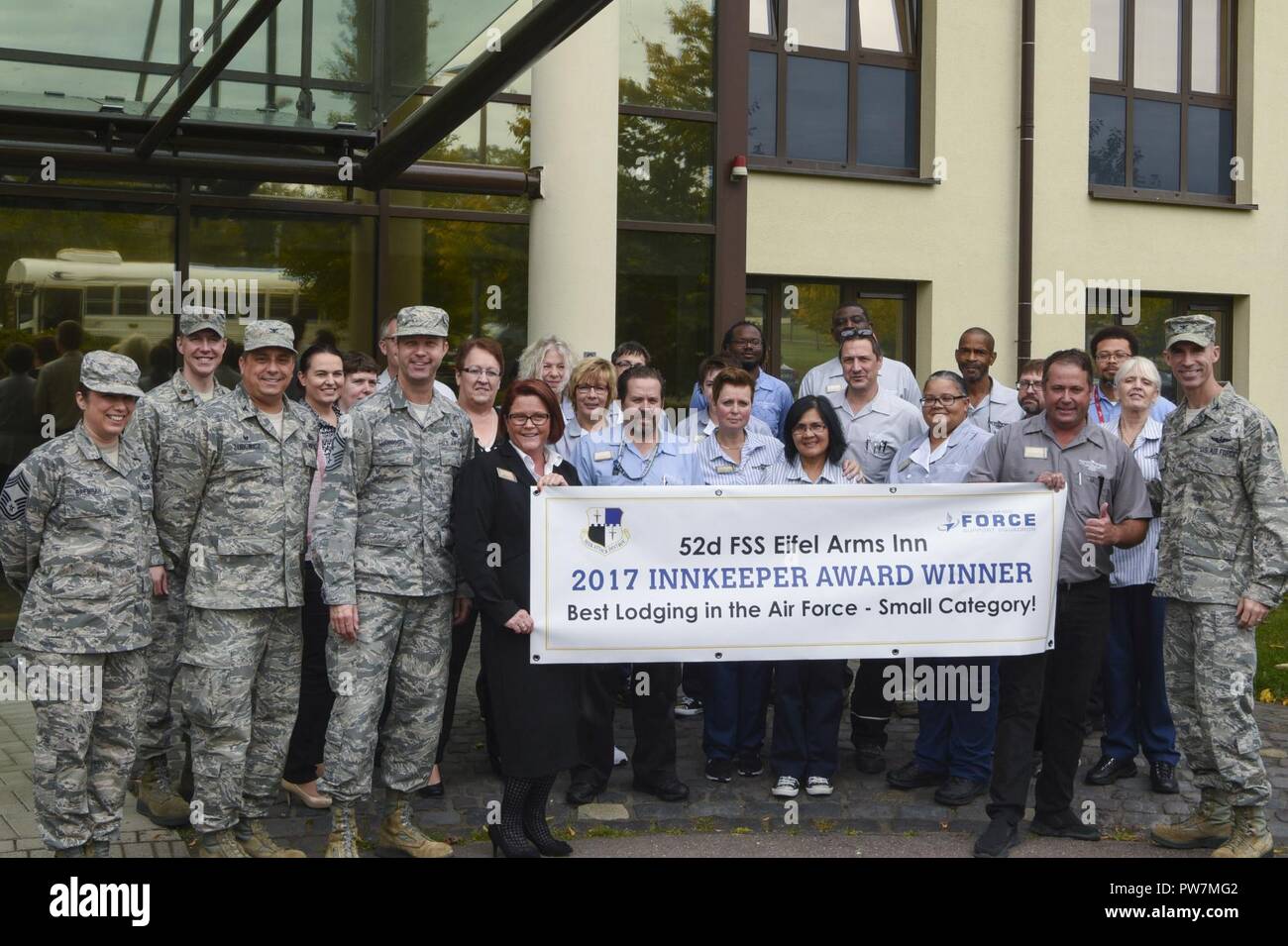 Col. Jason Bailey, 52nd Fighter Wing command, and Chief Master Sgt. Edwin Ludwigsen, 52nd FW command chief, pose with members of the Eifel Arms Inn at Spangdahlem Air Base, Germany, September 26, 2017. The Eifel Arms Inn celebrated its fifth win as the Best Lodging in the Air Force - Small Category. Stock Photo