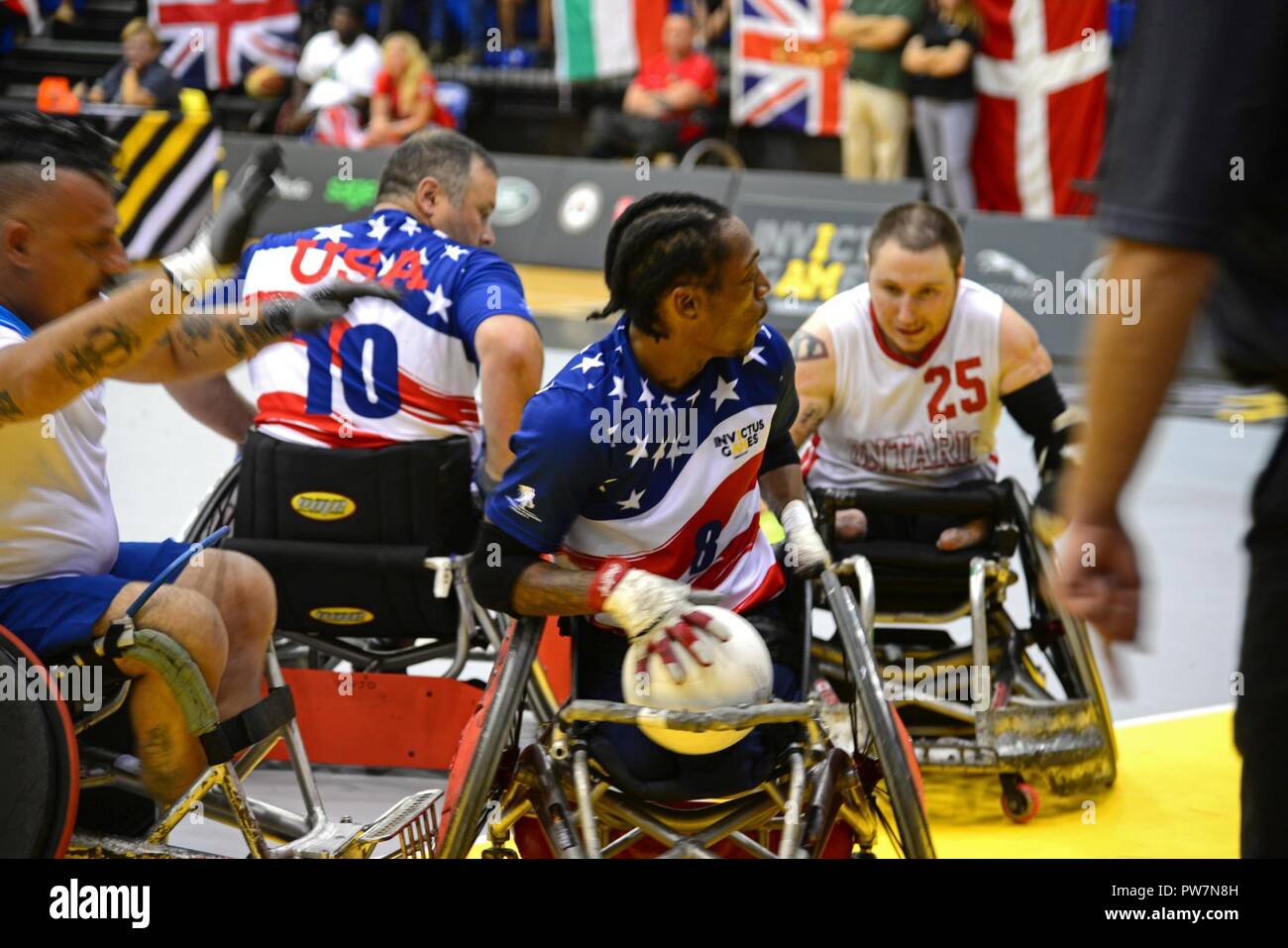 U.S. Marine Corps veteran Anthony McDaniel, a former sergeant and member of Team U.S., prepares for offensive maneuvering during a wheelchair rugby match at the 2017 Invictus Games in the Mattamy Sports Centre in Toronto, Canada, Sept. 27, 2017. The Invictus Games were established by Prince Harry of Wales in 2014, and have brought together wounded and injured veterans from 17 nations to compete across 12 adaptive sporting events. Stock Photo