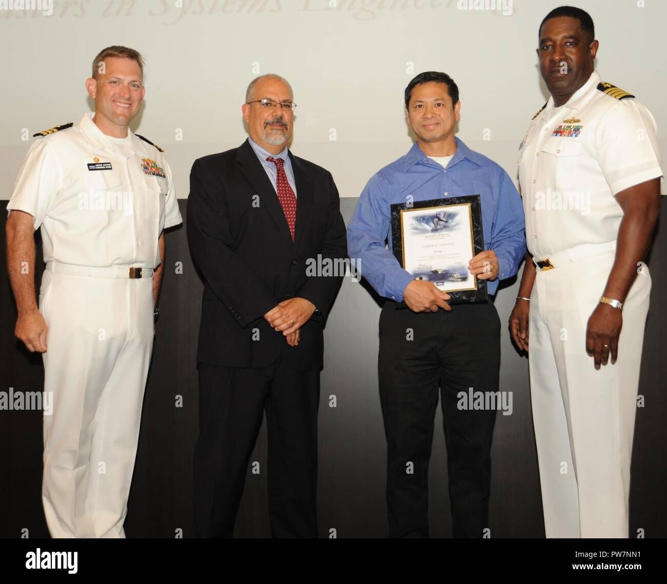 DAHLGREN, Va. Tu Ngo receives his certificate of achievement from