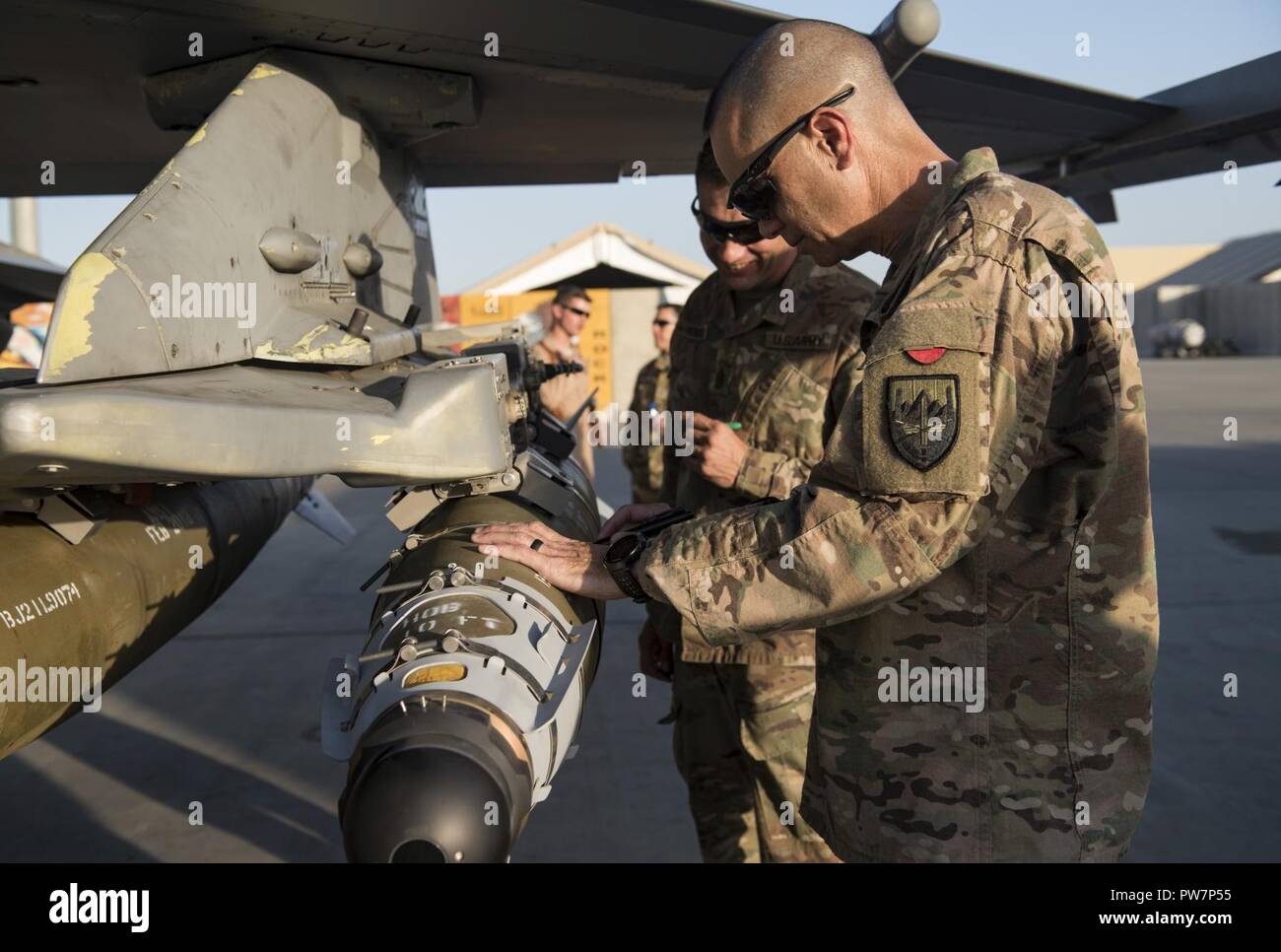 U.S. Army Maj. Gen. Leopoldo Quintas, the deputy commanding general of U.S. Forces Afghanistan, signs a bomb during a visit of the 455th Air Expeditionary Wing at Bagram Airfield, Afghanistan, Sept. 26, 2017. During his immersion of the 455th AEW, Quintas saw firsthand how Airmen deliver airpower and enable a successful train, advise, and assist campaign in Afghanistan. Stock Photo