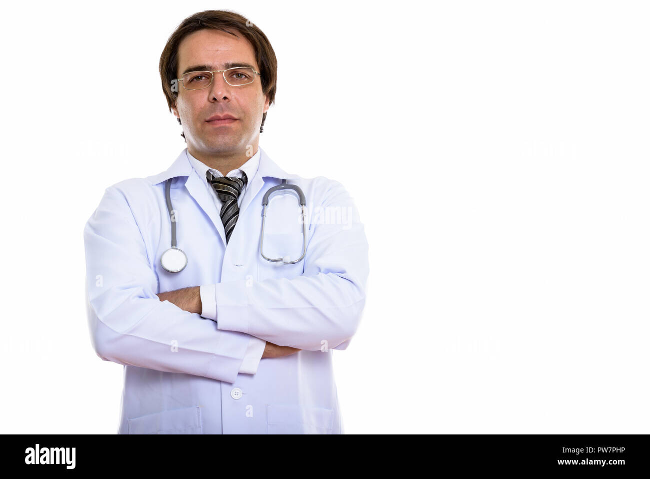 Studio shot of young Persian man doctor wearing eyeglasses with  Stock Photo