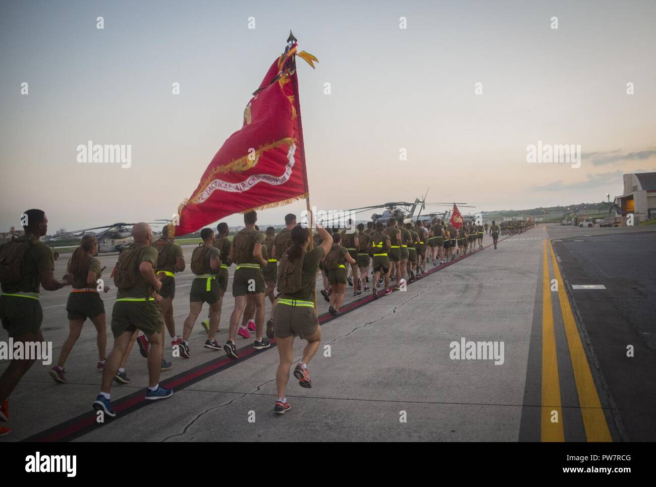 U.S. Marines with Marine Tactical Air Command Squadron 1, Marine Air Control Group 18, 1st Marine Aircraft Wing, sprint during 1st MAW’s suicide prevention and awareness run at Marine Corps Air Station Futenma, September 29, 2017. The run was held to increase awareness about suicide and highlight the resources available to help those in need. Stock Photo