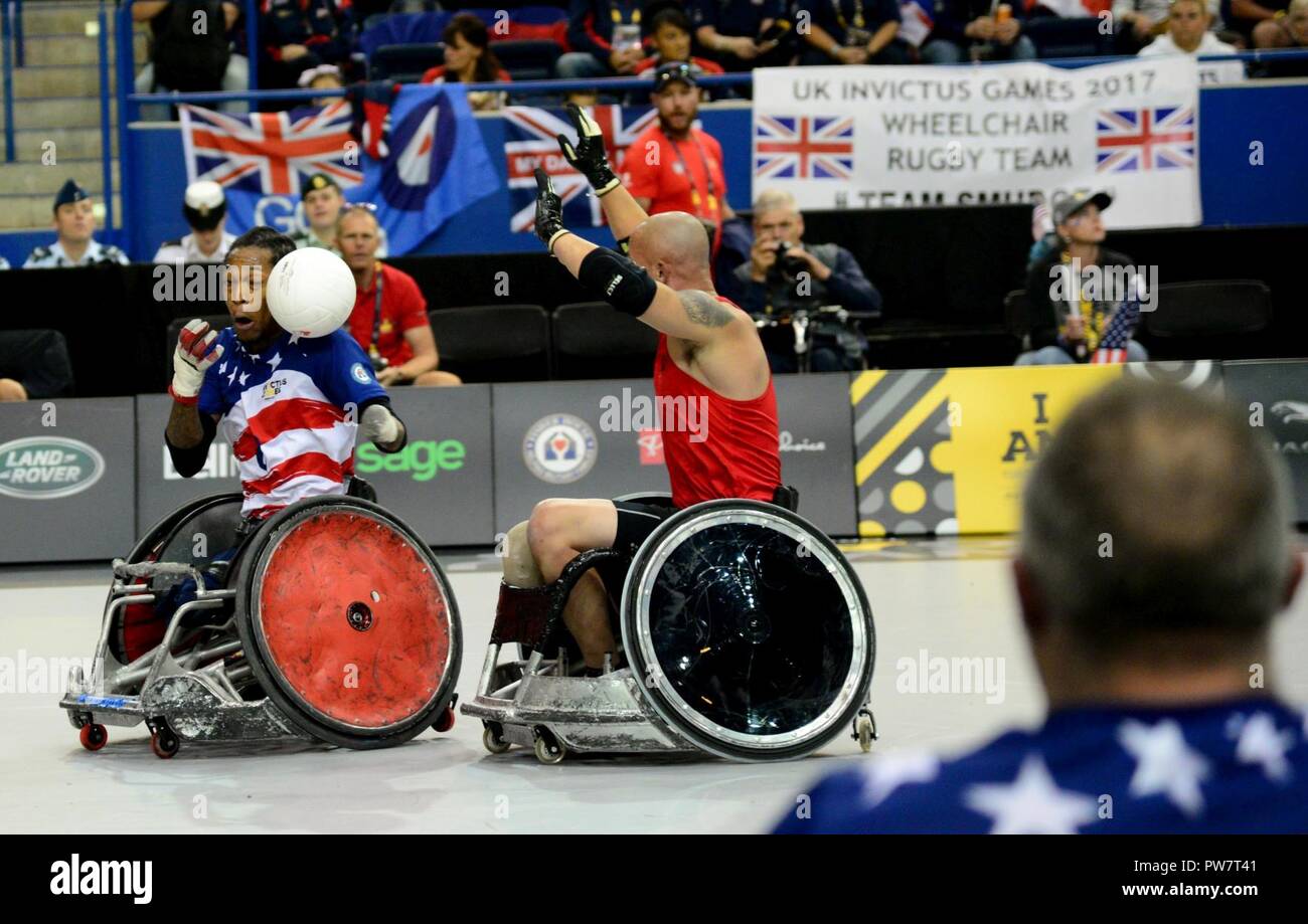 U.S. Marine Corps veteran Anthony McDaniel, a former sergeant and member of Team U.S., takes on an aggressive pass during wheelchair rugby finals at the 2017 Invictus Games in the Mattamy Athletic Centre in Toronto, Canada, Sept. 28, 2017. The Invictus Games were established by Prince Harry of Wales in 2014, and have brought together more than 550 wounded and injured veterans to take part in 12 adaptive sporting events. Stock Photo