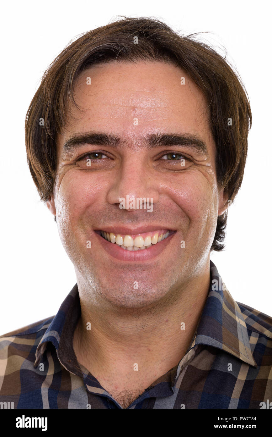 Face of young happy Persian man smiling Stock Photo