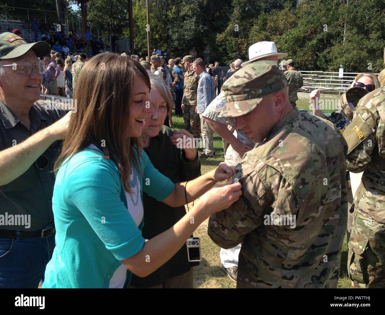 Idaho Army National Guard Soldier Sgt. David Robinson receives his Ranger tab from sister Melynda Robinson during a graduation held at Fort Benning, Georgia, Sept. 22. Stock Photo