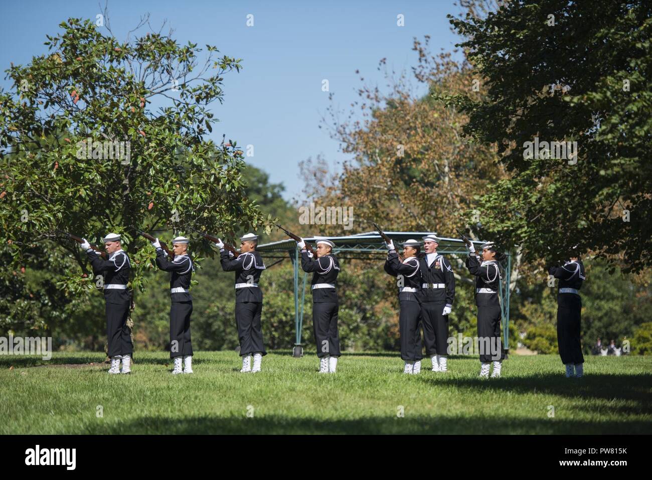 The U.S. Navy Ceremonial Guard and U.S. Navy Band participate in the graveside service for U.S. Navy Fireman 1st Class Walter B. Rogers at Arlington National Cemetery, Arlington, Va., Oct. 2, 2017.  Rogers perished on the USS Oklahoma when it was attacked by Japanese aircraft at Ford Island, Pearl Harbor on Dec. 7, 1941.  Remains of the deceased crew were recovered from December 1941 to June 1944 and were subsequently interred in the Halawa and Nu’uanu Cemeteries.  In September 1947, the remains were disinterred and 35 men from the USS Oklahoma were identified by the American Graves Registrati Stock Photo