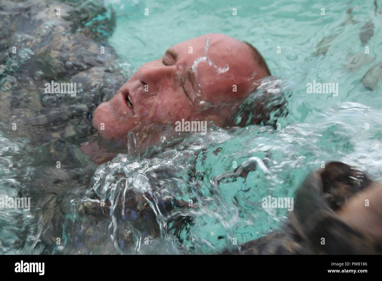 U.S. Army Staff Sgt. Eric Sullivan, assigned to the Blanchfield Army Community Hospital, reaches for the pool wall during the 2017 Best Medic Competition at Fort Bragg, N.C., Sept. 19, 2017. The competition tested the physical and mental toughness, as well as the technical competence, of each medic to identify the team moving forward to represent the region at the next level of the competition. Stock Photo