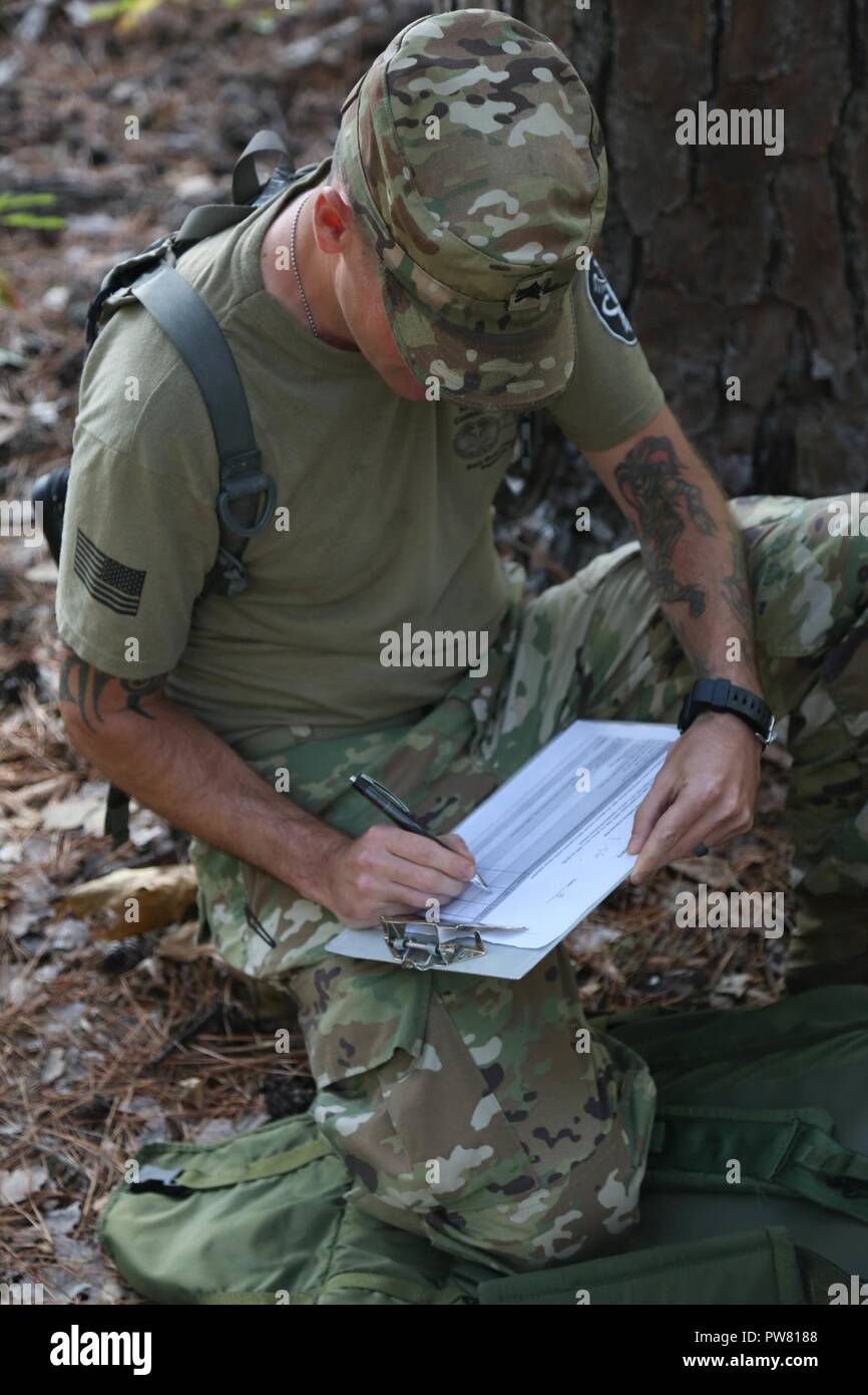 U.S. Army Sgt. Joshua Emmick, assigned to the Regional Health Command - Atlantic, grades the competitors during the 2017 Best Medic Competition at Fort Bragg, N.C., Sept. 19, 2017. The competition tested the physical and mental toughness, as well as the technical competence, of each medic to identify the team moving forward to represent the region at the next level of the competition. Stock Photo