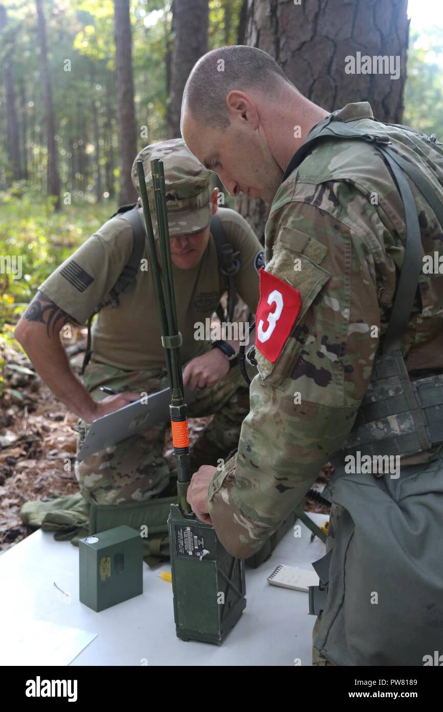 U.S. Army Sgt. 1st Class Zachary Dispennette, assigned to the McDonald Army Health Center, sends out a radio message during the 2017 Best Medic Competition at Fort Bragg, N.C., Sept. 19, 2017. The competition tested the physical and mental toughness, as well as the technical competence, of each medic to identify the team moving forward to represent the region at the next level of the competition. Stock Photo