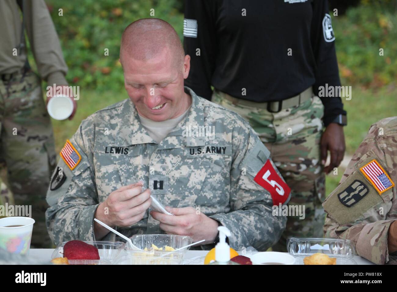 U.S. Army Capt. Jeremy Lewis, assigned to the Public Health Command - Atlantic, enjoys a hot breakfast after completing the 2017 Best Medic Competition at Fort Bragg, N.C., Sept. 20, 2017. The competition tested the physical and mental toughness, as well as the technical competence, of each medic to identify the team moving forward to represent the region at the next level of the competition. Stock Photo