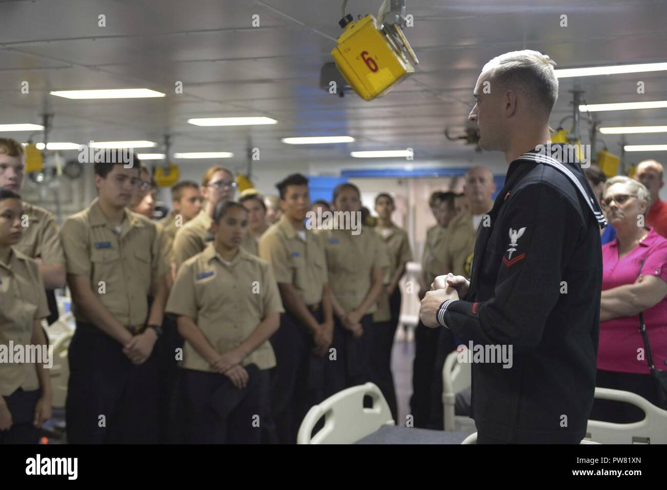 SAN FRANCISCO (Oct. 2, 2017) Hospital Corpsman 3rd Class Alexander Corey speaks to students of the Turlock High School Navy Junior Reserve Officers Training Corps touring the Wasp-class amphibious assault ship USS Essex (LHD 2) during Fleet Week San Francisco. Fleet week provides an opportunity for the American public to meet their Navy, Marine Corps, and Coast Guard team and to experience America’s sea services. Fleet Week San Francisco will highlight naval personnel, equipment, technology, and capabilities, with an emphasis on humanitarian assistance and disaster response. Stock Photo