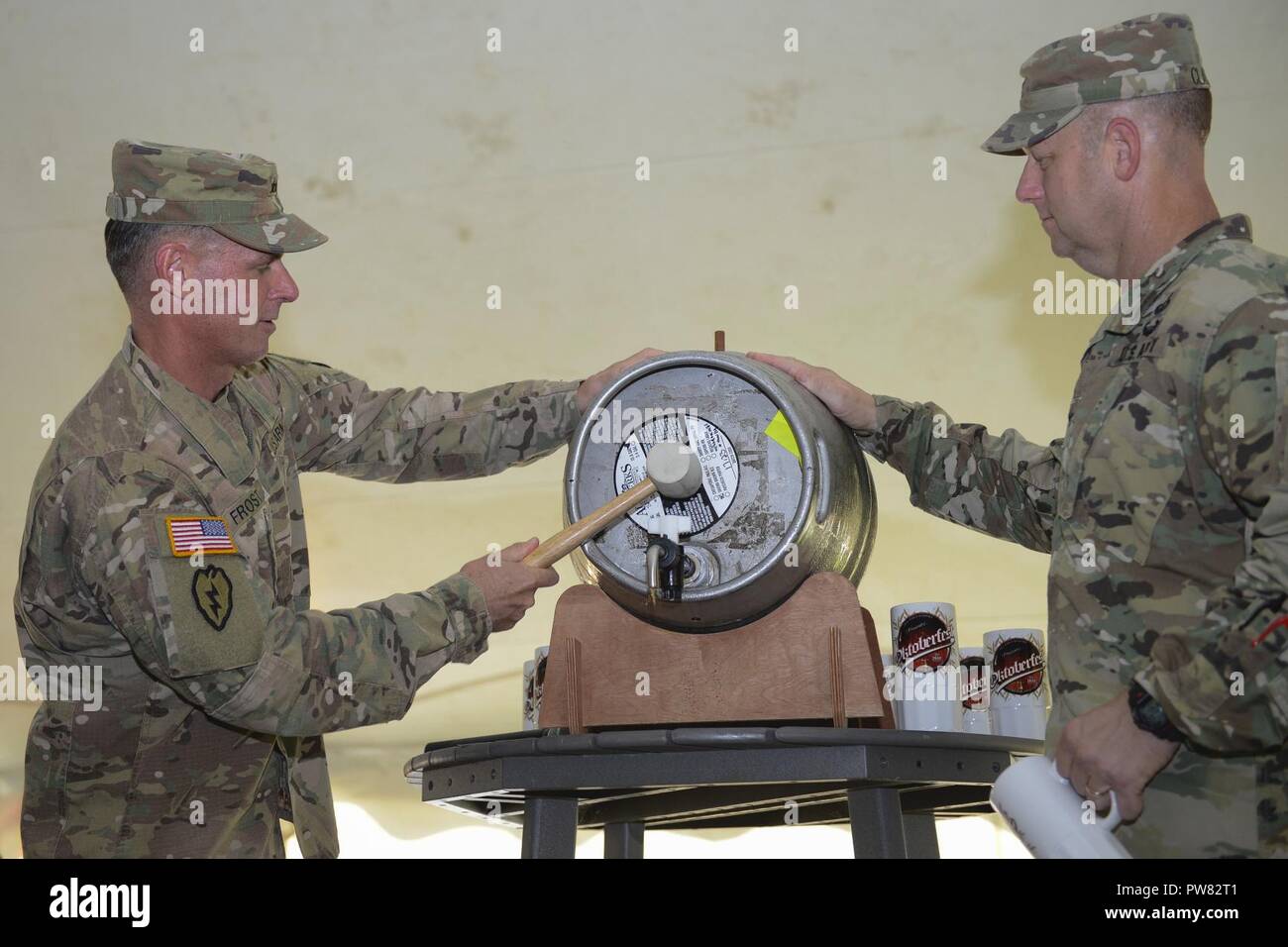 From left, U.S. Army Maj. Gen. Malcolm B. Frost, Center for Initial Military Training commanding general, and Col. Ralph L. Clayton III, 733rd Mission Support Group commander, tap the keg to officially start the Oktoberfest celebration at Joint Base Langley-Eustis, Va., Sept. 22, 2017. The first Oktoberfest was held in 1810 in Munich, Germany, to honor the marriage between Prince Ludwig and Therese of Saxe-Hildburghausen. Stock Photo