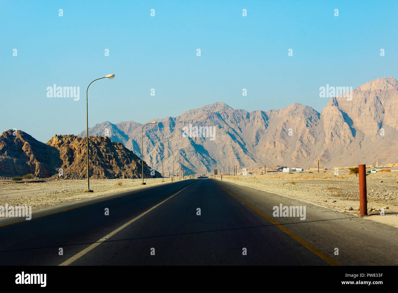 Scenic desert road surrounded by rocks in Musandam Oman Stock Photo