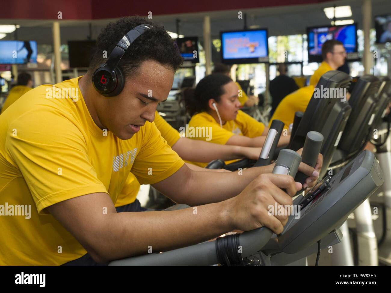 NORFOLK (Sept. 22, 2017) Information Systems Technician 3rd Class Shandon Williams uses a stationary bike during a physical fitness test for the Nimitz-Class aircraft carrier USS George Washington (CVN 73). George Washington is undergoing a refueling and complex overhaul (RCOH) at Newport News Shipyard. RCOH is a four-year project performed only once during a carrier’s 50-year service life that includes refueling of the ship’s two nuclear reactors, as well as significant repair, upgrades and modernizations. Stock Photo