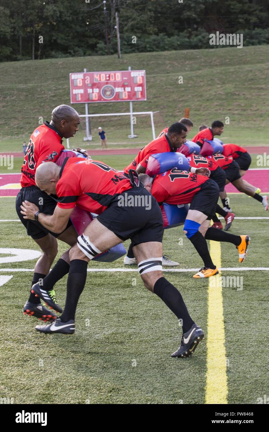 U.S. Marines assigned to the All Marine Rugby Team participate in warm up  drills before the start of an exhibition game between the All Marine Rugby  Team and Royal Navy Rugby Team