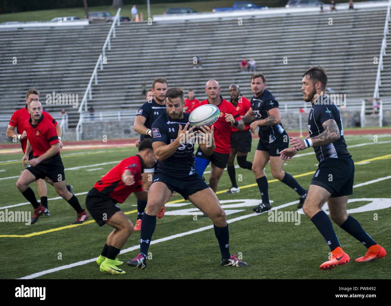 A Royal Sailor assigned the Royal Navy Rugby Team attempts to catch the