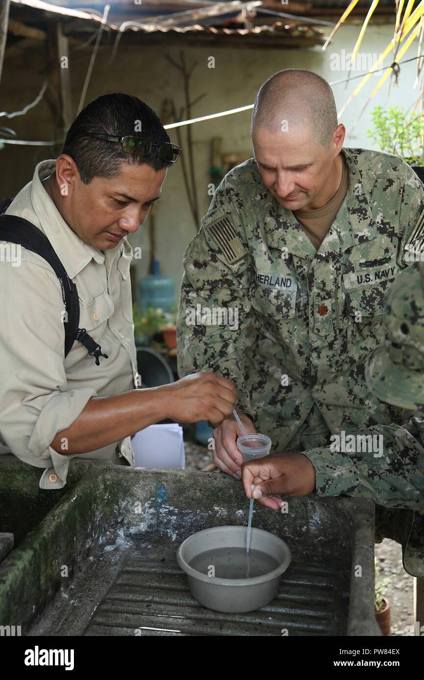 PUERTO BARRIOS, Guatemala (Oct. 3, 2017) U.S. Navy Lt. Cmdr. Ian Sutherland, the technical director for Navy Entomology Center of Excellence, and Dr. Hector Soriano, head of entomology and vector control for Department of Izabal, investigate local neighborhoods as part of insect and disease control efforts, during Southern Partnership Station 17 (SPS 17). SPS 17 is a U.S. Navy deployment, executed by U.S. Naval Forces Southern Command/U.S. 4th Fleet, focused on subject matter expert exchanges with partner nation militaries and security forces in Central and South America. Stock Photo