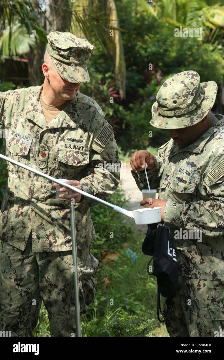 PUERTO BARRIOS, Guatemala (Oct. 3, 2017) U.S. Navy Lt. Cmdr. Ian Sutherland, left, and Hospital Corpsman 1st Class Dominic Ladmirault, both assigned to Navy Entomology Center of Excellence, collect mosquito larvae from local neighborhoods for insect and disease control, during Southern Partnership Station 17 (SPS 17). SPS 17 is a U.S. Navy deployment, executed by U.S. Naval Forces Southern Command/U.S. 4th Fleet, focused on subject matter expert exchanges with partner nation militaries and security forces in Central and South America. Stock Photo