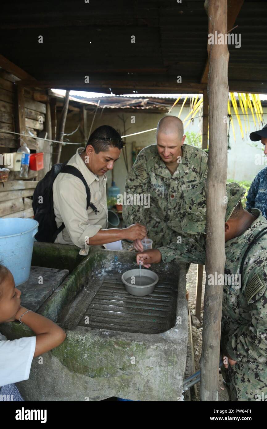 PUERTO BARRIOS, Guatemala (Oct. 3, 2017) U.S. Navy Lt. Cmdr. Ian Sutherland, technical director for Navy Entomology Center of Excellence, and Dr. Hector Soriano, head of entomology and vector control for Department of Izabal, investigate local neighborhoods as part of insect and disease control efforts, during Southern Partnership Station 17 (SPS 17). SPS 17 is a U.S. Navy deployment, executed by U.S. Naval Forces Southern Command/U.S. 4th Fleet, focused on subject matter expert exchanges with partner nation militaries and security forces in Central and South America. Stock Photo