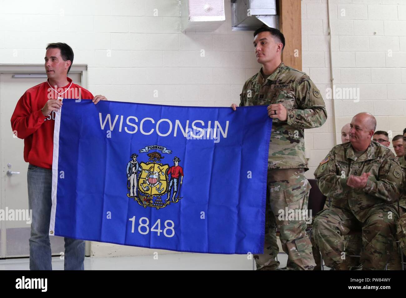 Gov. Scott Walker presents Capt. Jared LeFaivre, commander of