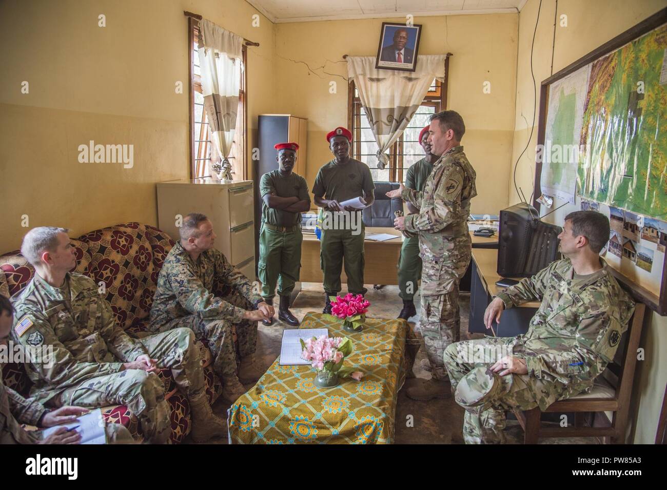 U.S. Army Capt. Robert Kobold (second from right), a civil affairs team  leader deployed to the Combined Joint Task Force-Horn of Africa, gives an  operations brief to U.S. Marine Corps Brig. Gen.