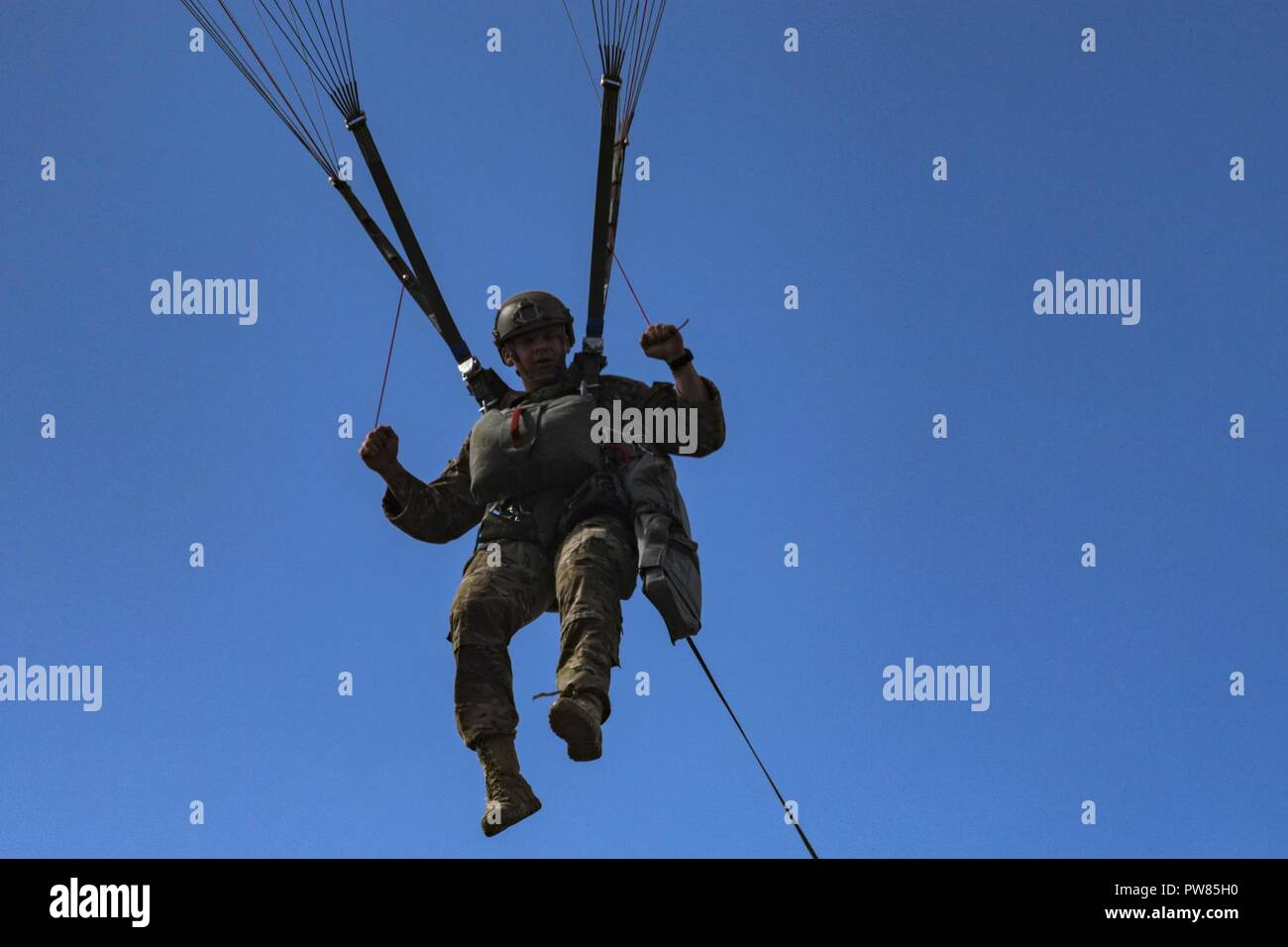 A member of the 820th Base Defense Group (BDG) descends during a static-line jump, Oct. 3, 2017, at the Lee Fulp drop zone in Tifton, Ga. The 820th Combat Operations Squadron’s four-person shop of parachute riggers are responsible for ensuring every 820th BDG parachute is serviceable, while also ensuring ground safety at the drop zone. The team has packed and inspected more than 490 parachutes in 2017. Stock Photo