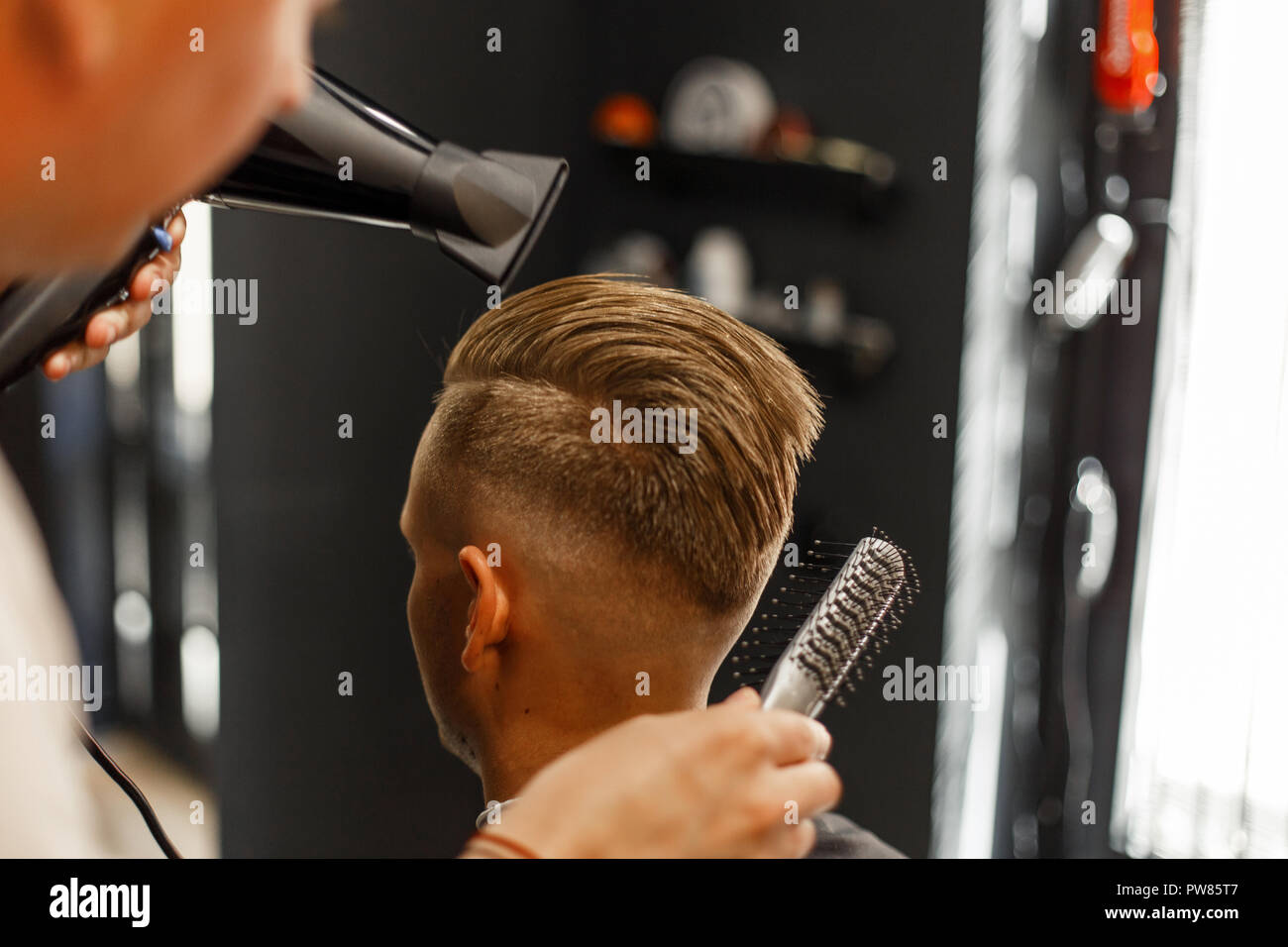 Create a male hairstyle and hair styling. Barbershop. Lifestyle Stock Photo  - Alamy