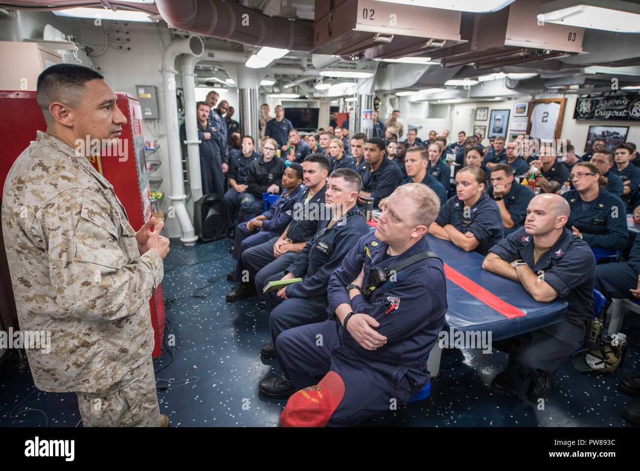 5TH FLEET AREA OF OPERATIONS (Sept. 20, 2018) Marine Lt. Col. Rudy Salcido, operations officer for the 13th Marine Expeditionary Unit, speaks to Sailors aboard the guided-missile destroyer USS Jason Dunham (DDG 109). Salcido served with Cpl. Jason Dunham and the 3rd Battalion 7th Marines during the Iraq War when Dunham was killed in action. USS Jason Dunham is deployed to the U.S. 5th Fleet area of operations in support of naval operations to ensure maritime stability and security in the Central Region, connecting the Mediterranean and the Pacific through the western Indian Ocean and three str Stock Photo